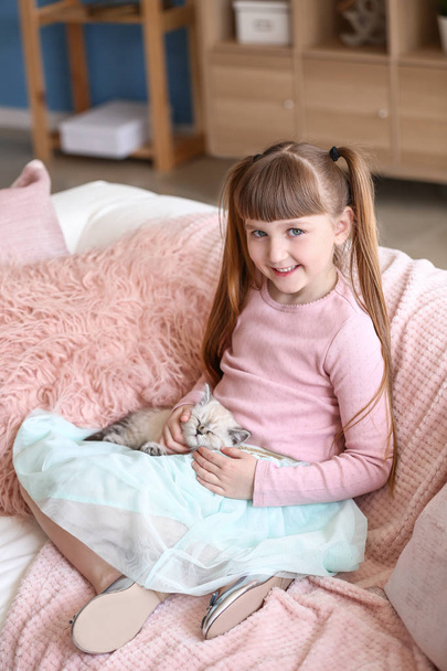 Girl with cute fluffy kitten at home - Fotografie, Obrázek