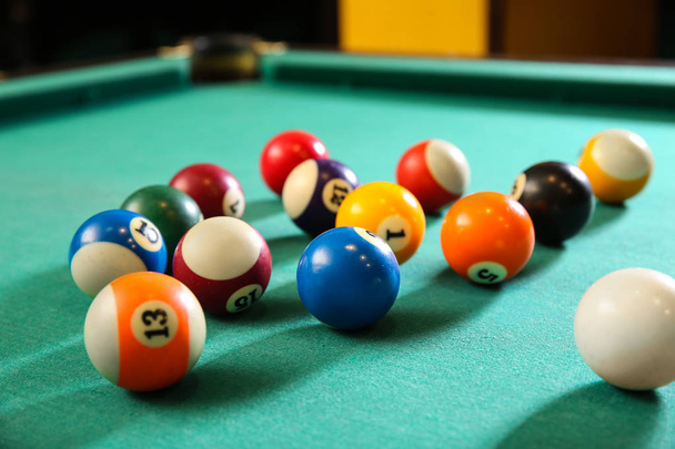 Billiard balls on table in club - Фото, изображение