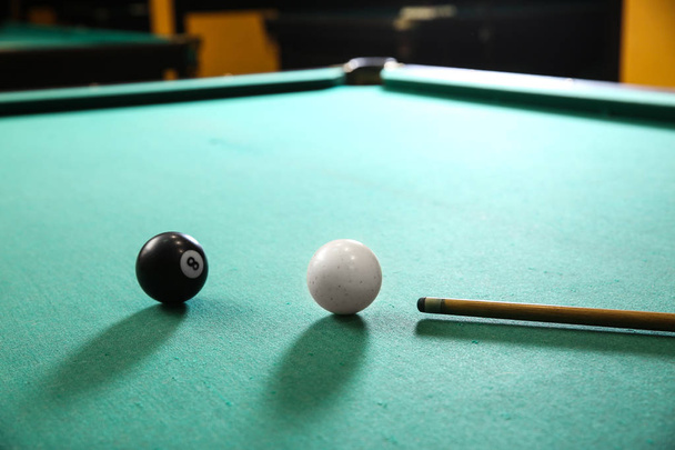 Billiard balls with cue on table in club - Photo, Image