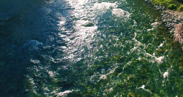 Low altitude flight over fresh fast mountain river with rocks at sunny summer morning. - Video, Çekim