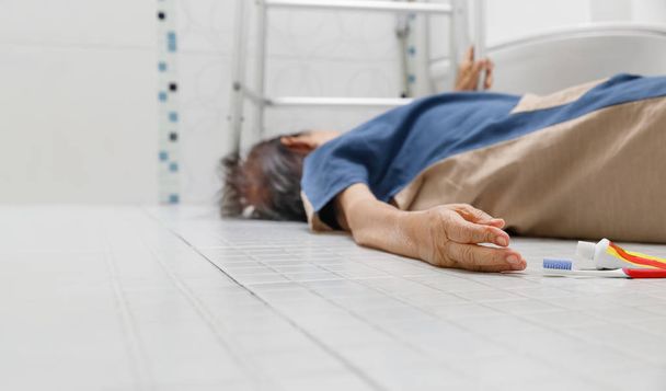 Elderly woman falling in bathroom because slippery surfaces - Photo, Image