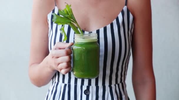 Woman holding a glass with celery juice - Footage, Video