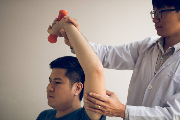 Asian physiotherapists help raise arms for patients to raise dum - Photo, Image