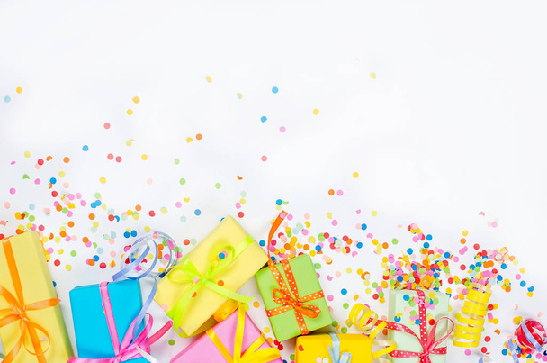 Colorful assorted confetti with serpentine and gift boxes on whi - 写真・画像
