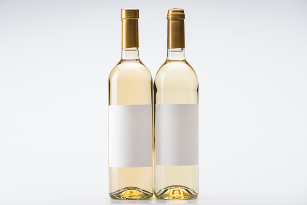 bottles of white wine with blank labels on white background - Foto, Imagem