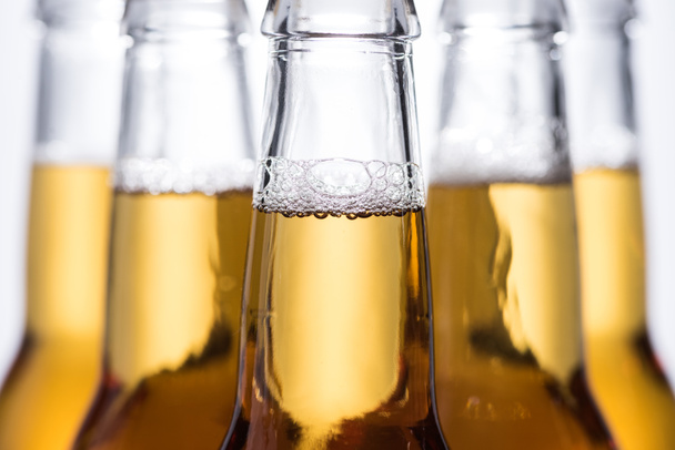 selective focus of beer bottles with bubbles - Φωτογραφία, εικόνα