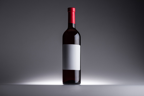 bottle of red wine and blank label on dark background with back light - Photo, Image