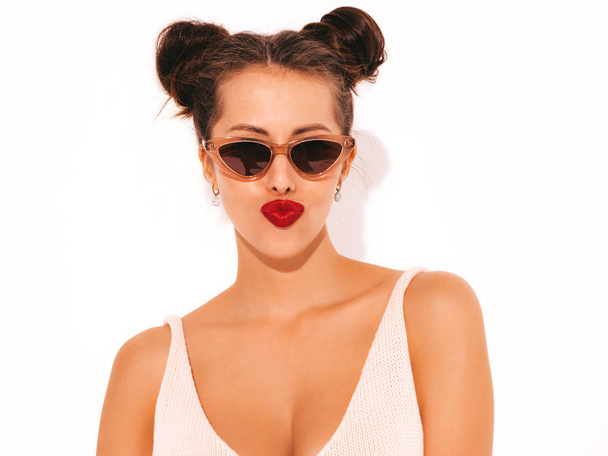 Closeup portrait.Young beautiful sexy hipster woman with red lips in sunglasses.Trendy girl in summer swimwear bathing suit. Positive female makes duck face.Funny model isolated on white.Two horns - Фото, зображення