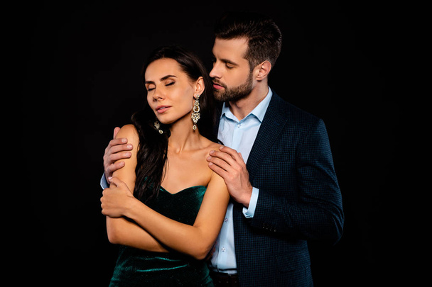 Close up photo rich pair classy she her chic eyes closed enjoy he him his hold touch shoulders tenderness piggyback pose wear blue plaid costume jacket velvet green dress isolated black background - Zdjęcie, obraz