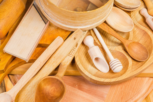 Pile of different wooden kitchen utensils, fragment - Фото, изображение