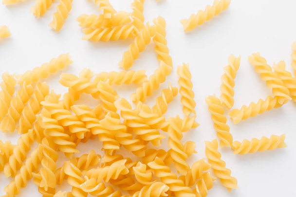 pile of uncooked macaroni on white background     - Foto, Imagen