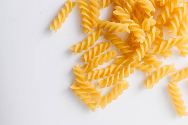 pile of uncooked macaroni on white background     - Foto, immagini