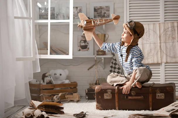Boy in his room playing with plane - Foto, imagen