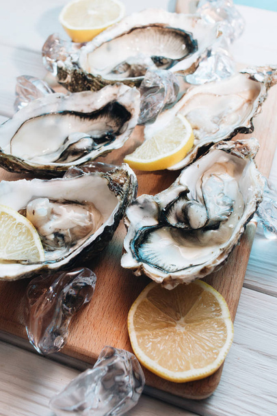 delicious oysters with lemon, seafood delicacy - Photo, Image