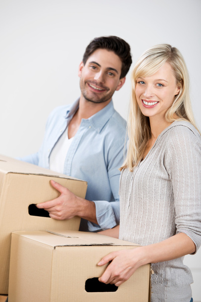 Couple Carrying Cardboard Boxes At Home - Photo, Image
