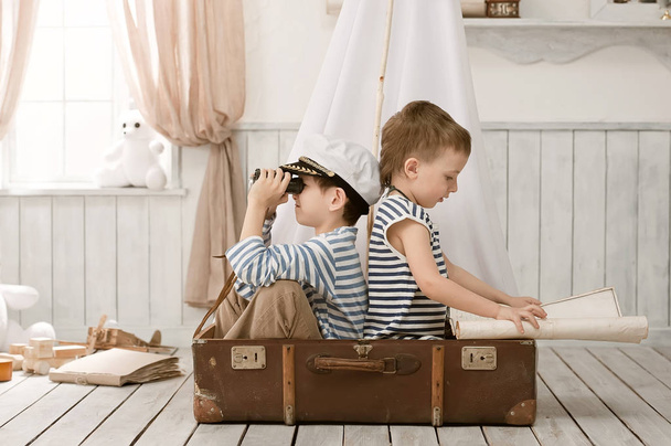 Boys in the image of sailors playing in her room  - Фото, изображение
