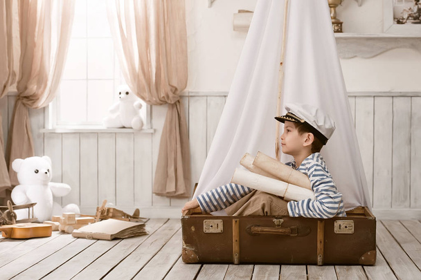 Boy in the image of sailor playing in her room  - 写真・画像