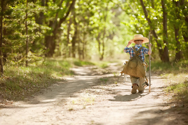 Boy on a forest road with backpacks - Foto, immagini