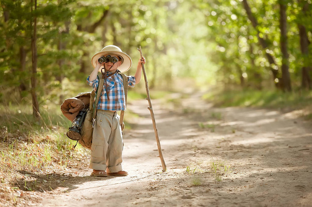 Boy on a forest road with backpacks - Foto, Imagem