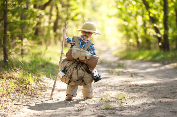 Boy on a forest road with backpacks - Фото, изображение