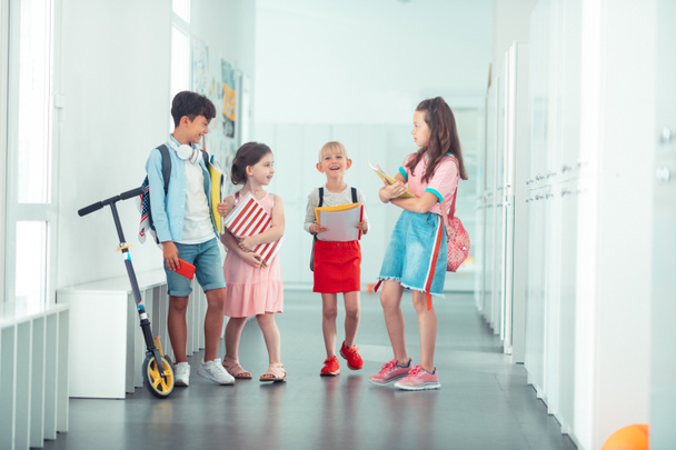 Cheerful stylish children going to the classroom together - Фото, зображення