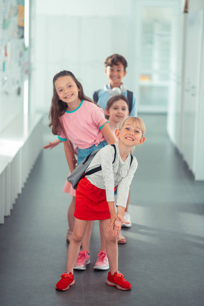Girls and one boy having fun during school break - Foto, Imagen
