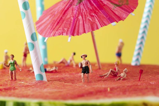 personnes miniatures en maillot de bain sur une pastèque
 - Photo, image