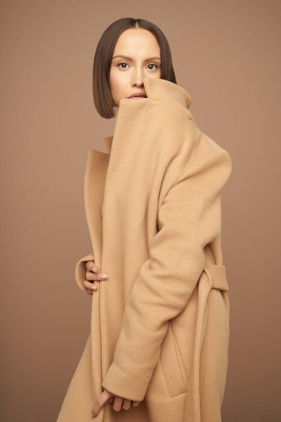 Fashion beautiful lady in beige coat - Photo, image