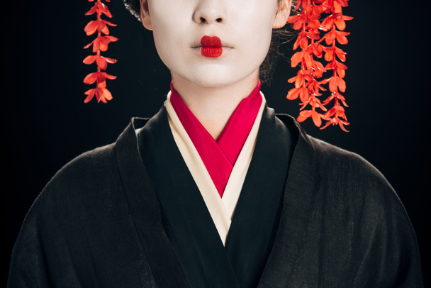 partial view of beautiful geisha in black and red kimono isolated on black - Photo, image