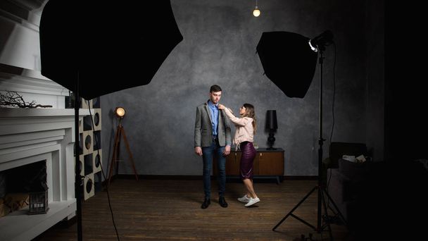 young beautiful woman helps to dress a man together in photo stu - Fotografie, Obrázek