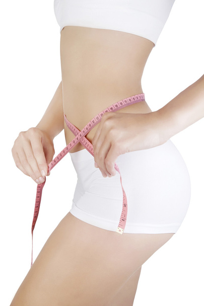 Woman measuring her waistline - Fotografie, Obrázek