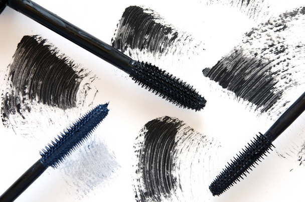 Stroke of black mascara with applicator brush close-up, isolated on white background. - Image - Photo, Image