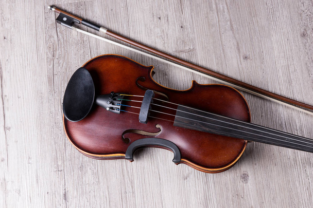 Classical violin isolated on wooden background. Studio shot of old violin. Classical musical instrument - Photo, Image