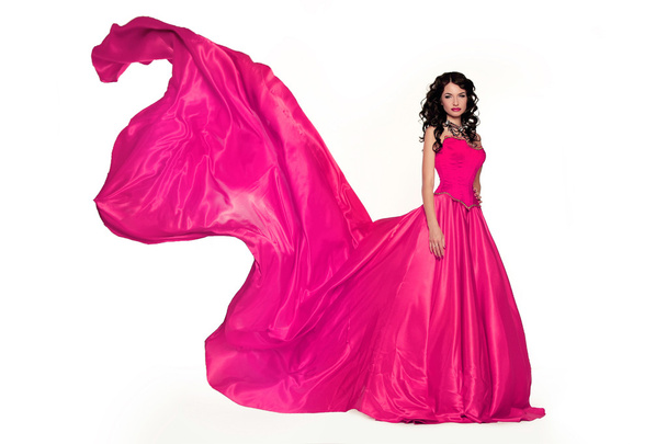 Beautiful woman model posing in luxuriant dress in the studio - Фото, изображение