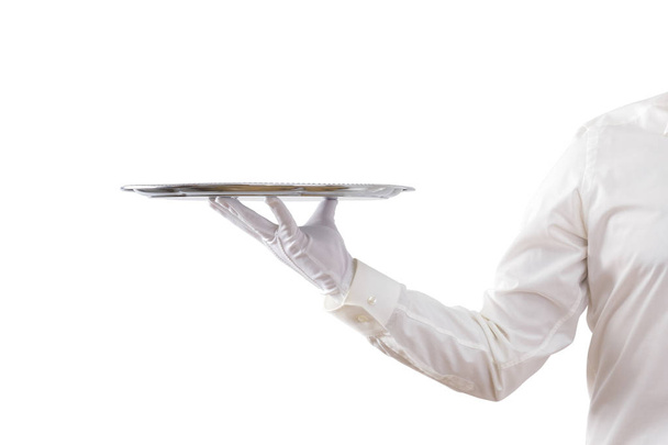 Kellner hält leeres Silbertablett isoliert auf weißem Hintergrund  - Foto, Bild