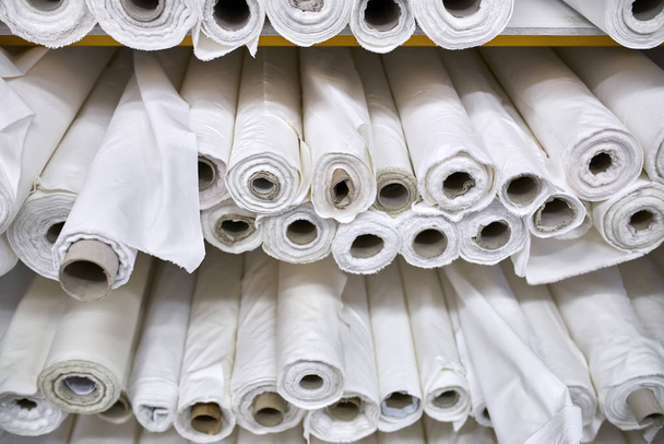 Fabric warehouse with many multicolored textile rolls - Foto, Imagem