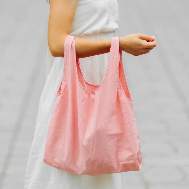 Woman holding cotton eco bag. Reusable eco bag for shopping. Zero waste concept. Mock up - Фото, изображение