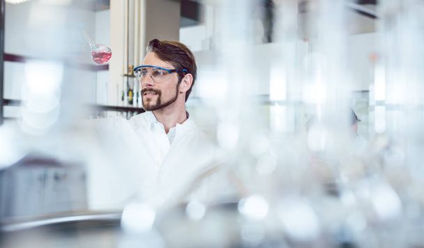 Research scientist shot though bottles in his lab - Foto, Bild