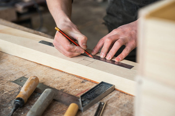 The worker makes measurements of a wooden board - Fotó, kép