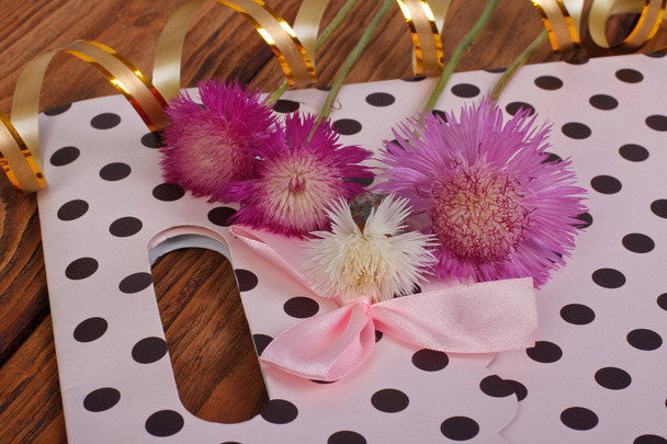 Bolsa de regalo rosa con lazo y acianos
 - Foto, imagen