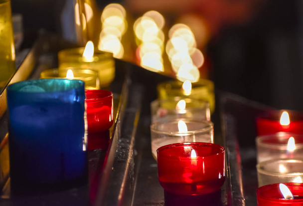 Candles inside a church. Sensation of religiosity and tranquility. Bokeh lights as space for text - Photo, Image
