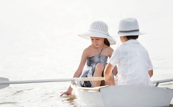 Boy with a girl riding on a boat - Fotoğraf, Görsel