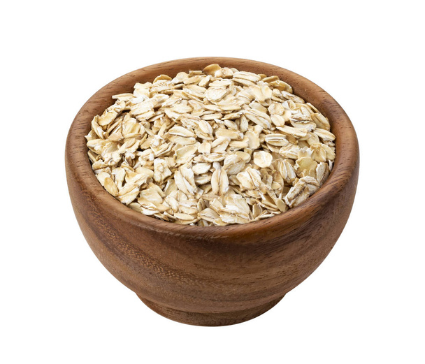 Oat flakes in wooden bowl isolated on white background - Photo, Image