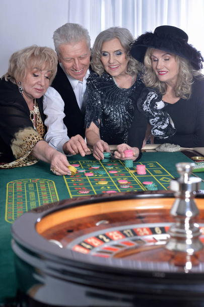 senior people playing in casino, spending time together  - Fotografie, Obrázek
