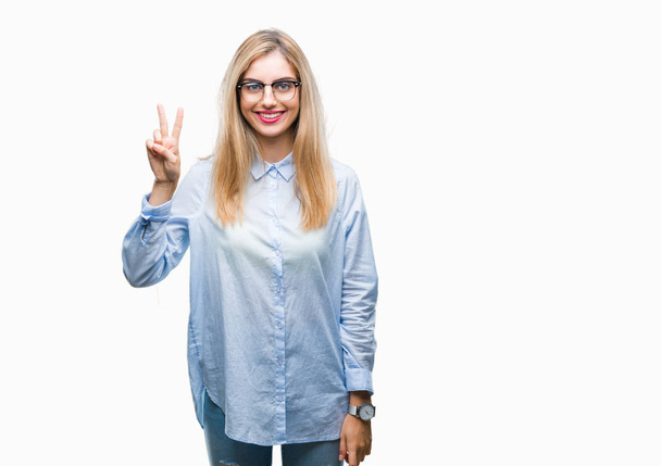 Young beautiful blonde business woman wearing glasses over isolated background showing and pointing up with fingers number two while smiling confident and happy. - Φωτογραφία, εικόνα