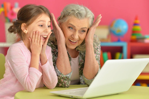 portrait of happy grandmother and daughter using laptop   - Foto, Imagen
