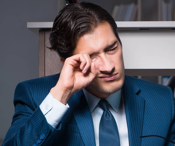 Businessman working overtime long hours late in office - Photo, image