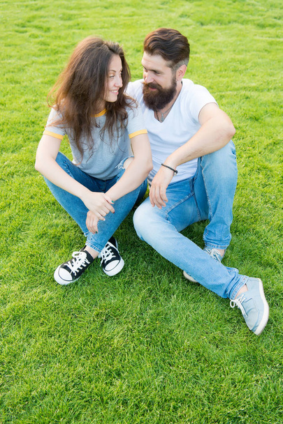 Couple in love relaxing on green lawn. Lovely couple outdoors. Soulmates closest people. Simple happiness. Couple relations goals. Couple spend time in nature. Playful girlfriend and boyfriend dating - Photo, image