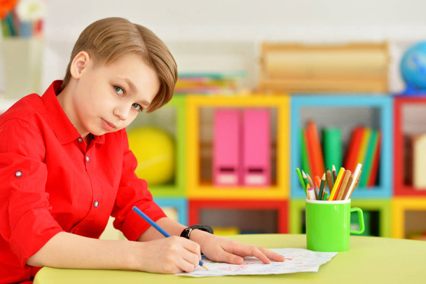 Portrait of cute little boy drawing with pencils - Фото, зображення