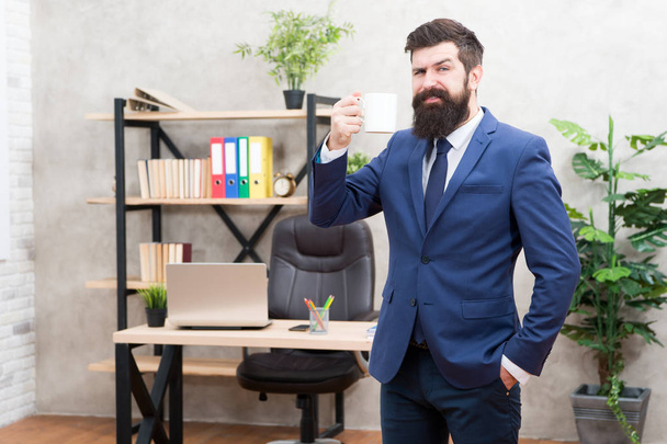 Coffee is always good idea. Start day with coffee. Successful people drink coffee. Coffee relaxing break. Boss enjoying energy drink. Caffeine addicted. Man bearded businessman hold cup stand office - 写真・画像